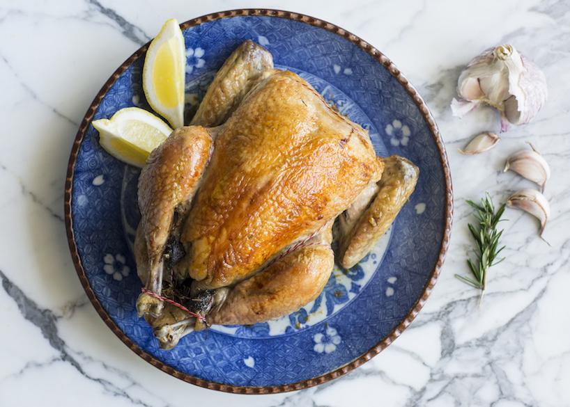Inside out, herb butter-stuffed whole organic chicken